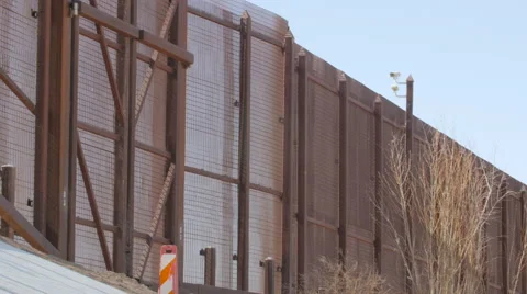 Looking Up at the Fence Between the US and Mexico Stock Footage 60407116