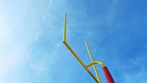 Looking up at a field goal during an American football game during a pan Stock Footage