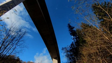 Looking up forward moving under concrete highway viaduct Stock Footage 121680063