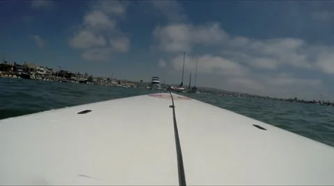 Looking forward from standup paddle boarding in mooring field by sailboat. Stock Footage 67580414