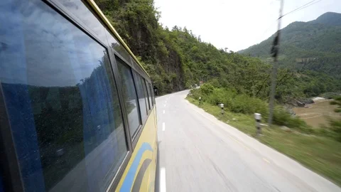 Looking forwards out of bus window in Nepal with green hills Video stock 91166177