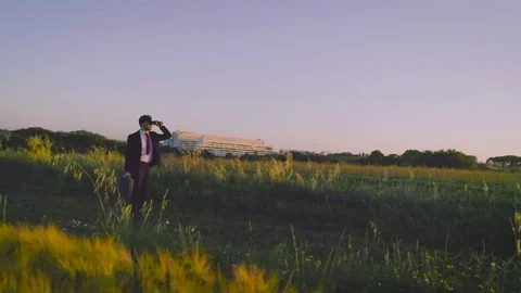 Looking to the future. Young businessman with elegant suit and briefcase walking Stock Footage 84098006