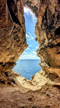 Looking Up from Għar ir-Riħ Cave at the Blue Sky and Limestone Cliffs, Malta Stock Photos