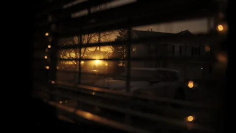 Looking at golden sunset through window closed by blinds. Close up shot Stock-Footage 303786772