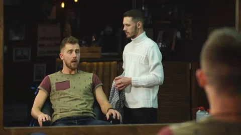 Looking good. Side view of handsome young bearded man looking at his reflection Stock Footage 70953886