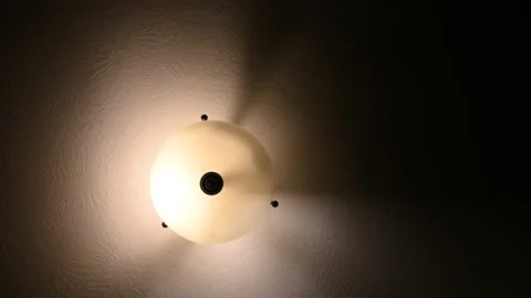 Looking up at a hanging light fixture with a flickering bulb Stock Footage 141761045