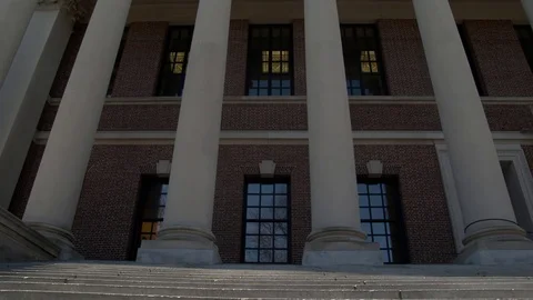 Looking up at historic brick building with four white columns at entrance Stock Footage 77378530
