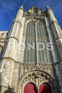 Looking up at Hooglandse Kerk church front with rounded steeples and blue sky Stock Photos