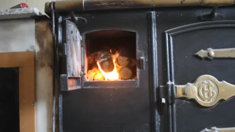 Looking how fire is burning in a wood stove Stock Footage 246833498