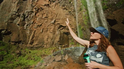 Looking up at huge waterfall spilling over rocks in national park Stock Footage 152801619