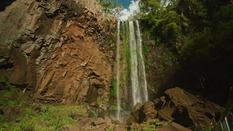 Looking up at huge waterfall spilling over rocks in State forest Stock Footage 152814008