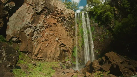 Looking up at huge waterfall spilling over rocks in State forest Stock Footage 152816302