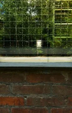 Looking inside an archive thru an grated and reflecting window Stock Photos