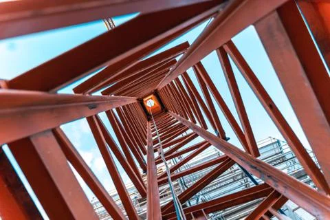 Looking up inside a construction crane from the ground. Stock Photos