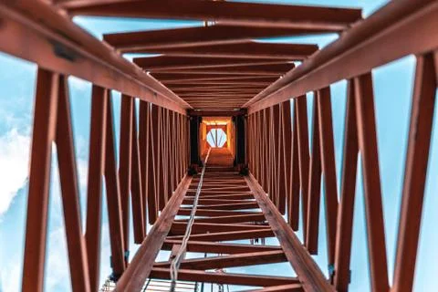 Looking up inside a construction crane from the ground. Stock Photos