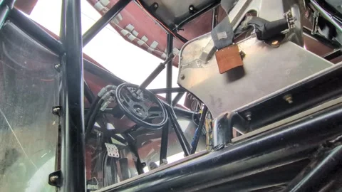 Looking up inside a custom race vehicle cockpit Stock Footage 347484455