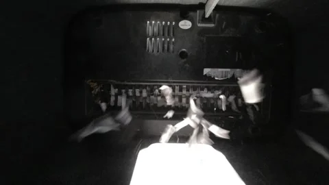 Looking up from inside a paper shredder while is shreds paper Stock Footage 308672278