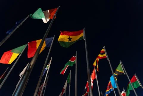 Looking Up at International Flags at Night in Doha Qatar Flag Plaza with Co.. Stock Photos