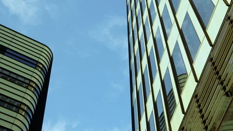 Looking up at a juxtaposition of curved and angular modern skyscrapers Stock Footage 255825969