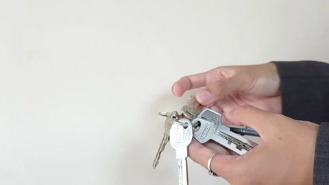 Looking for a key to a bedroom with a white background Stock Footage 145621183