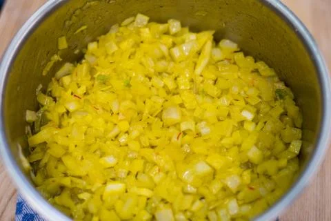 Looking into large pot with almost translucent onion cubes Stock Photos