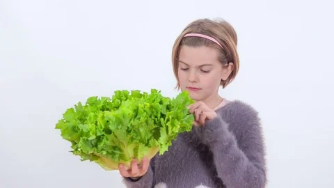 Looking at a lettuce in her hands Stock Footage 83724408