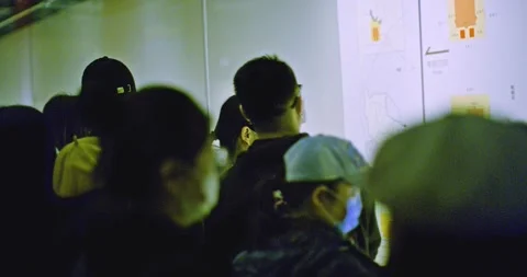 Looking at Map amongst crowd of people In museum Stock Footage 143389463