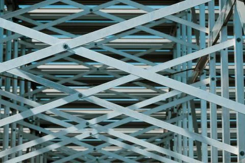 Looking up at metal pattern underneath bleachers Stock Photos