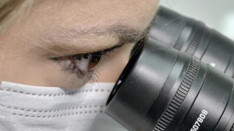 Looking into the microscope and discover a cure Stock Photos