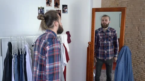 Looking into the mirror buttoning the shirt's sleeves Putting together an outfit Stock Footage 147893367