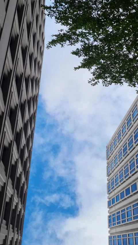 Looking Up at Modern Angular Building Facade and Blue Sky Vidéo 345086334