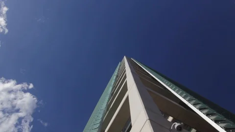Looking up at modern building with a CCTV camera Stock Footage 90837535