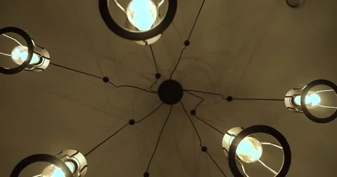 Looking up at a modern ceiling light fixture with glowing exposed bulbs Vídeos de archivo 342301217