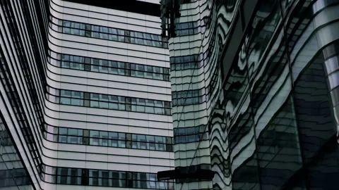 Looking at modern office buildings with reflections on glass wall, dolly shot Stock-Footage 150956926