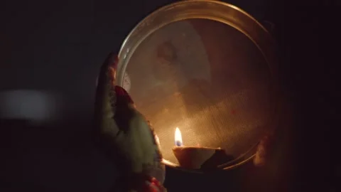 Looking at moon through a sieve during Karva Chauth celebration Video stock 220765717