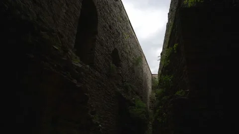 Looking up from a narrow passage between the massive stone defensive walls .. Stock-Footage 333206140
