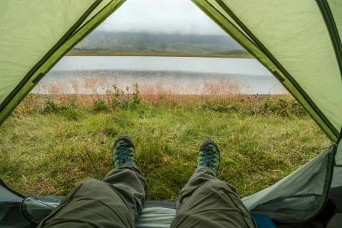 Looking at the nature from a tent in wild, while hiking in Iceland Stock Photos