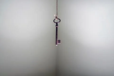 Looking up at old key hanging on string. Business success freedom Foto stock