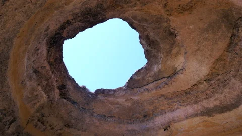 Looking up at the opening of Benagil sea cave. Gimbal, circling Stock Footage 149034687