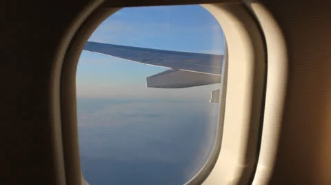 Looking out aeroplane window Stockbeeldmateriaal 24625732
