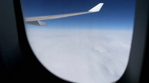 Looking out of airplane window with wing on dense cloud layer Stock Footage 54800658