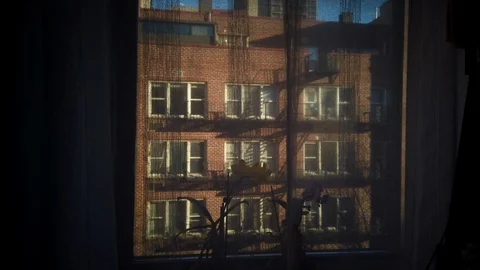 Looking out of the apartment window of a NYC Soho apartment during sunset Stock Footage 103102608