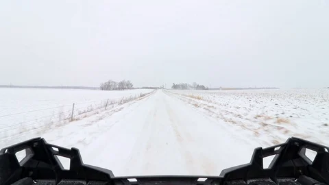 Looking out the back of a side-by-side ATV on a snowy road. 스톡 동영상 119983870