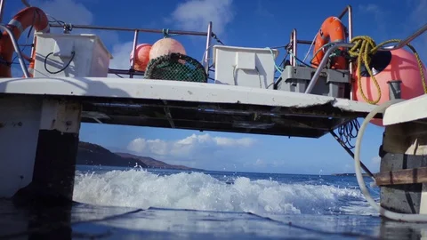 Looking out the back of a speeding creel fishing boat. Camera on the deck. 4K Stock Footage 93460432