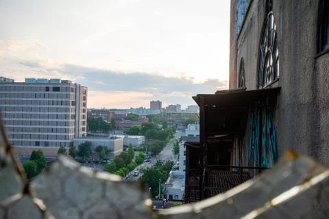Looking Out a Broken Window in an Abandoned Bulding at a City Street and Skyl Stock Photos
