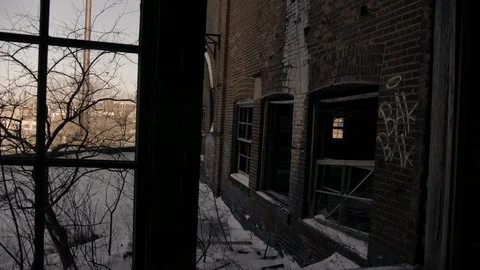 Looking out Broken Windows of Abandoned brick building in City winter Stock Footage 89944891