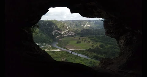 Looking out a cave onto the valley below. Stock Footage 147980022