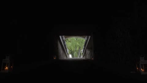 Looking Out from Dark Tunnel with Lanterns to Green Trees at Entrance 스톡 동영상 335209097