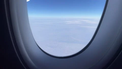 Looking out from flight window in the air Stockbeeldmateriaal 302474348
