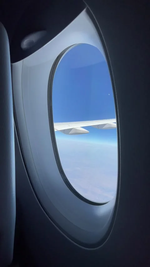 Looking out from flight window in the air Stockbeeldmateriaal 302474353